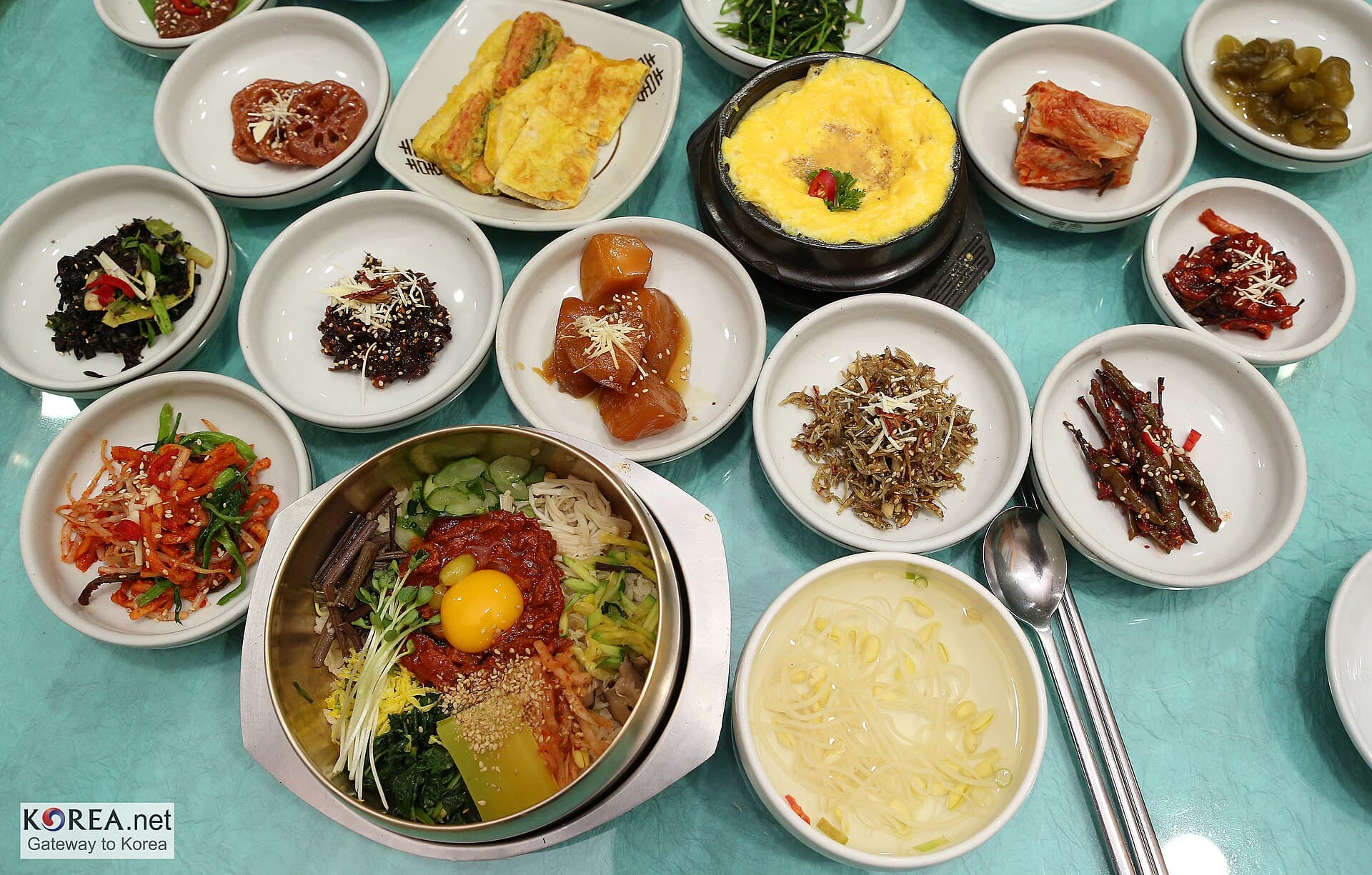 A Korean meal table set with bibimbap, banchan side dishes and gyeranjjim in Seoul