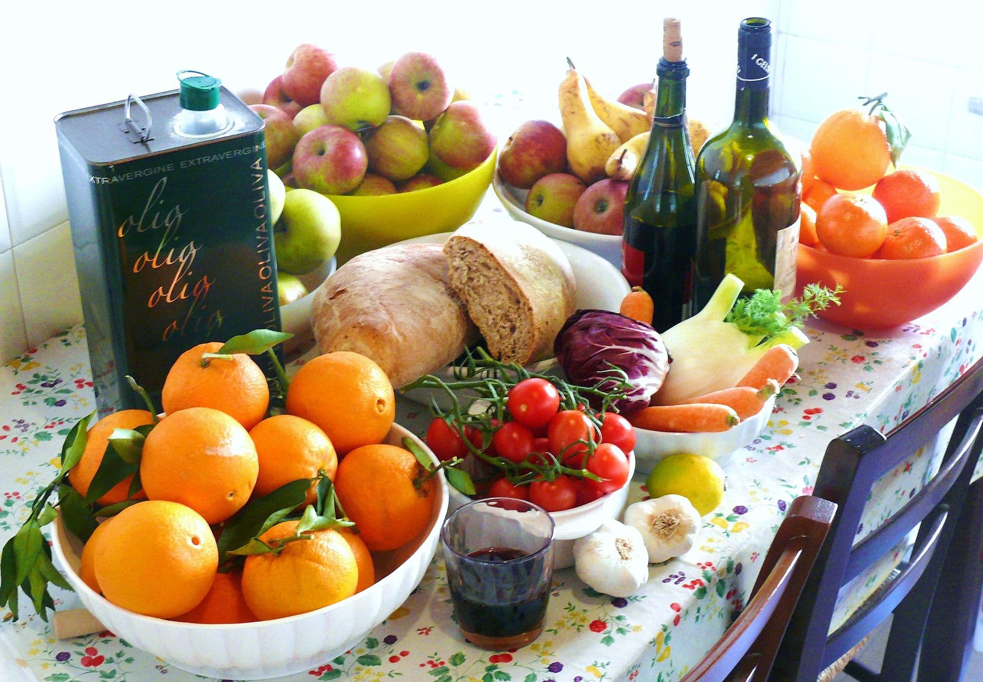 A spread of Mediterranean diet foods including produce, grains and olive oil