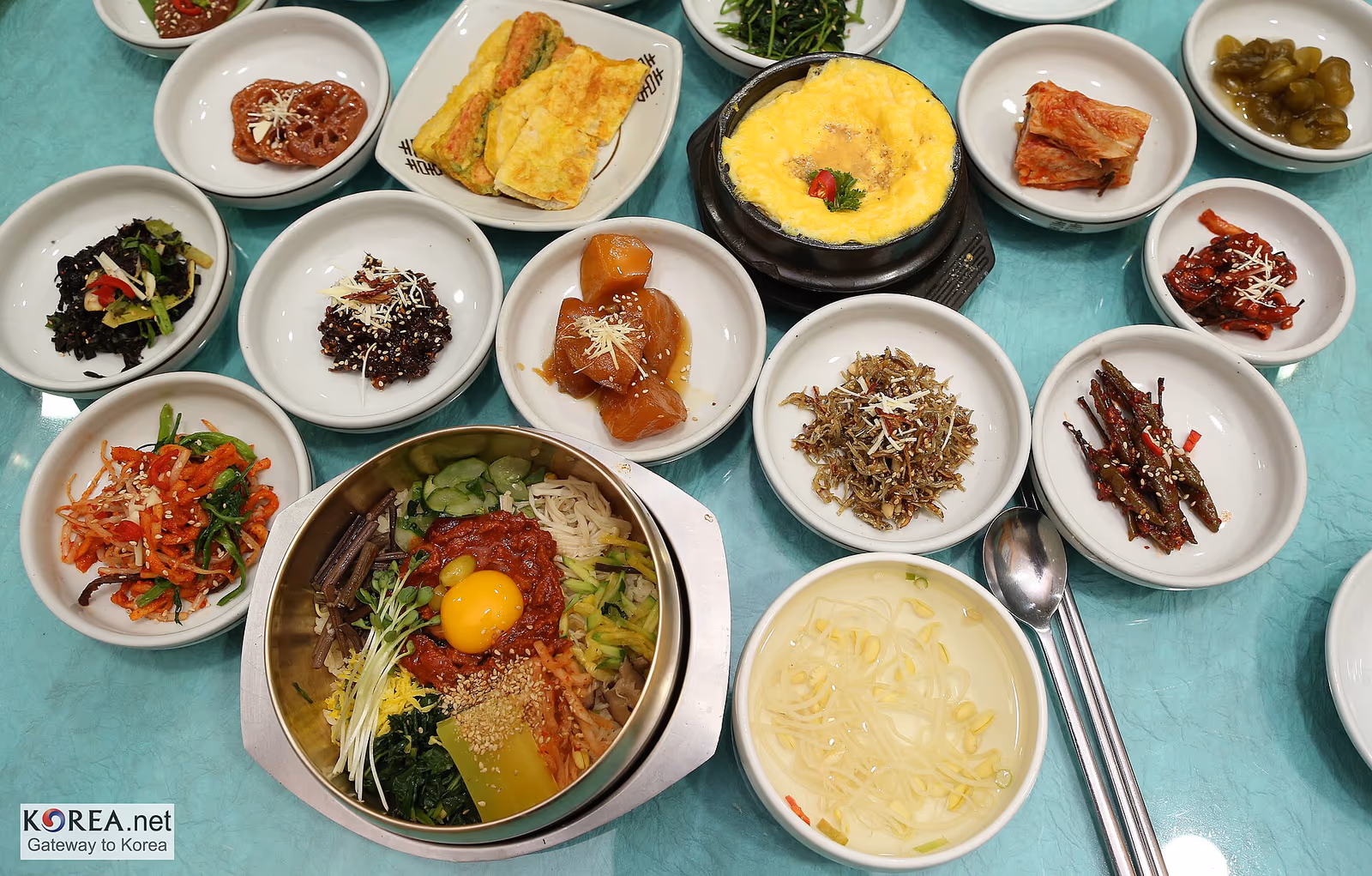 A Korean meal table set with bibimbap, banchan side dishes and gyeranjjim in Seoul